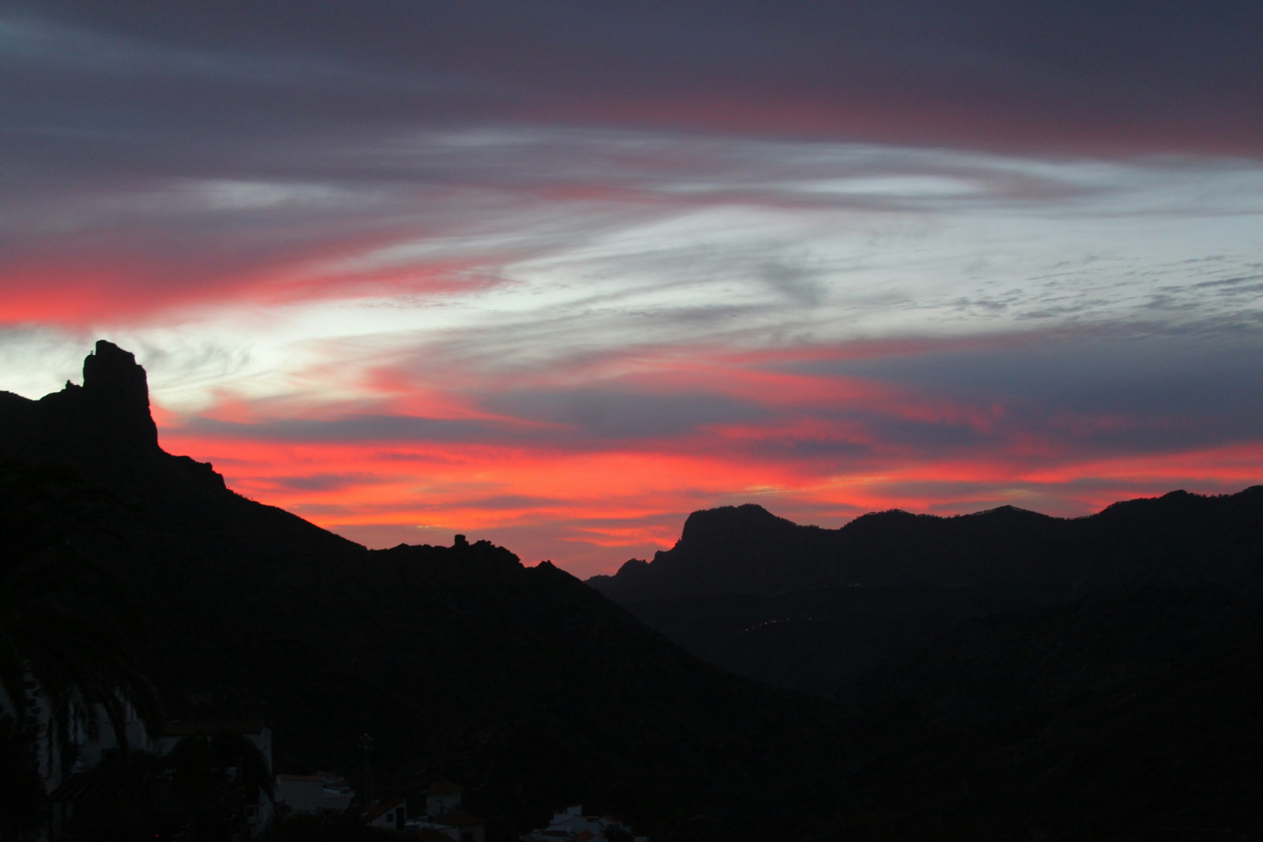 a sunset over mountains